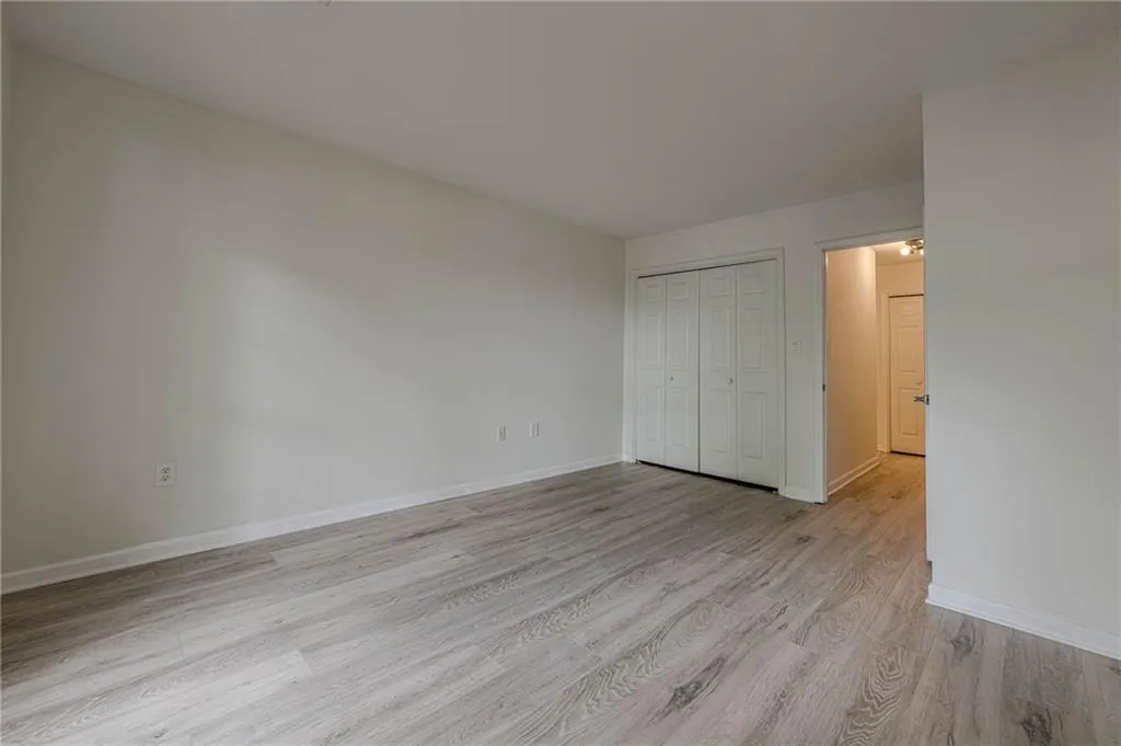 Unfurnished bedroom with light wood-style floors and a closet