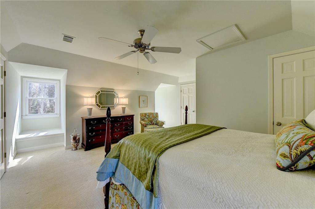 Bedroom featuring ceiling fan and light carpet