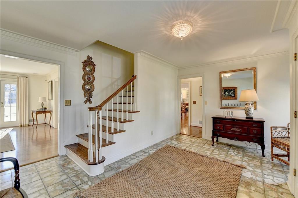 Staircase featuring light hardwood / wood-style floors and ornamental molding