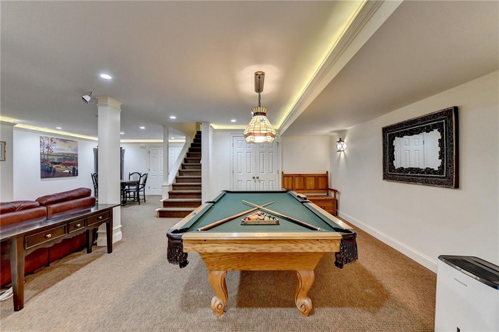 Game room with billiards and light colored carpet