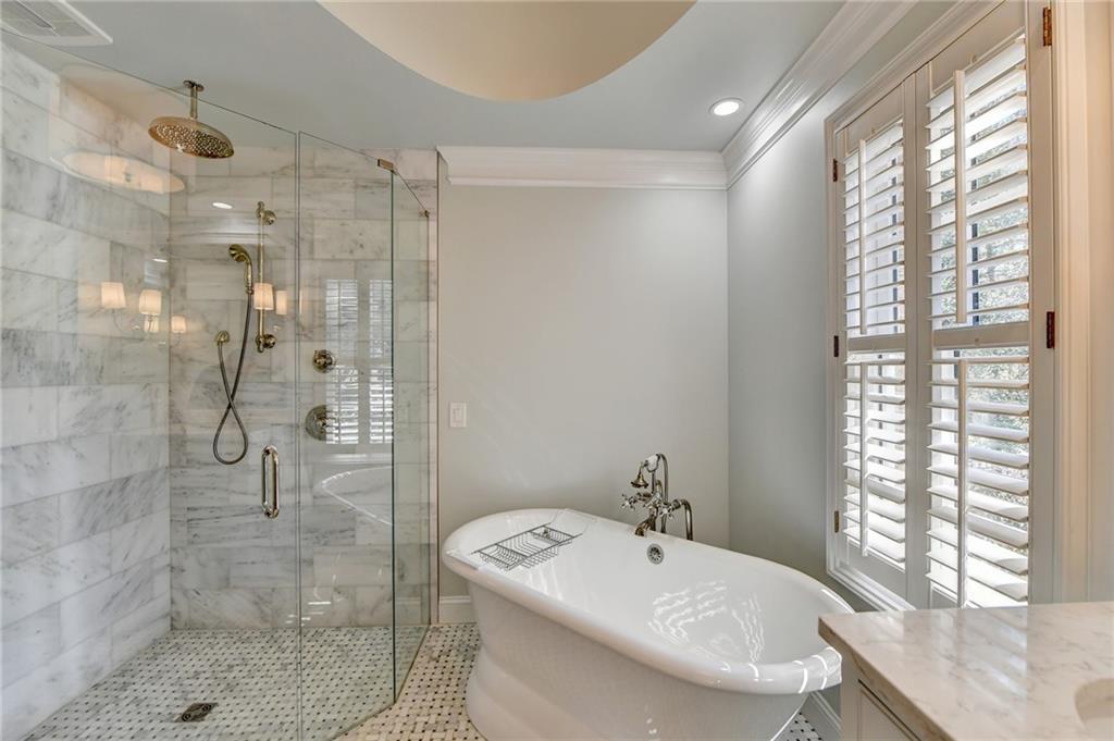 Bathroom featuring plenty of natural light, vanity, crown molding, and shower with separate bathtub