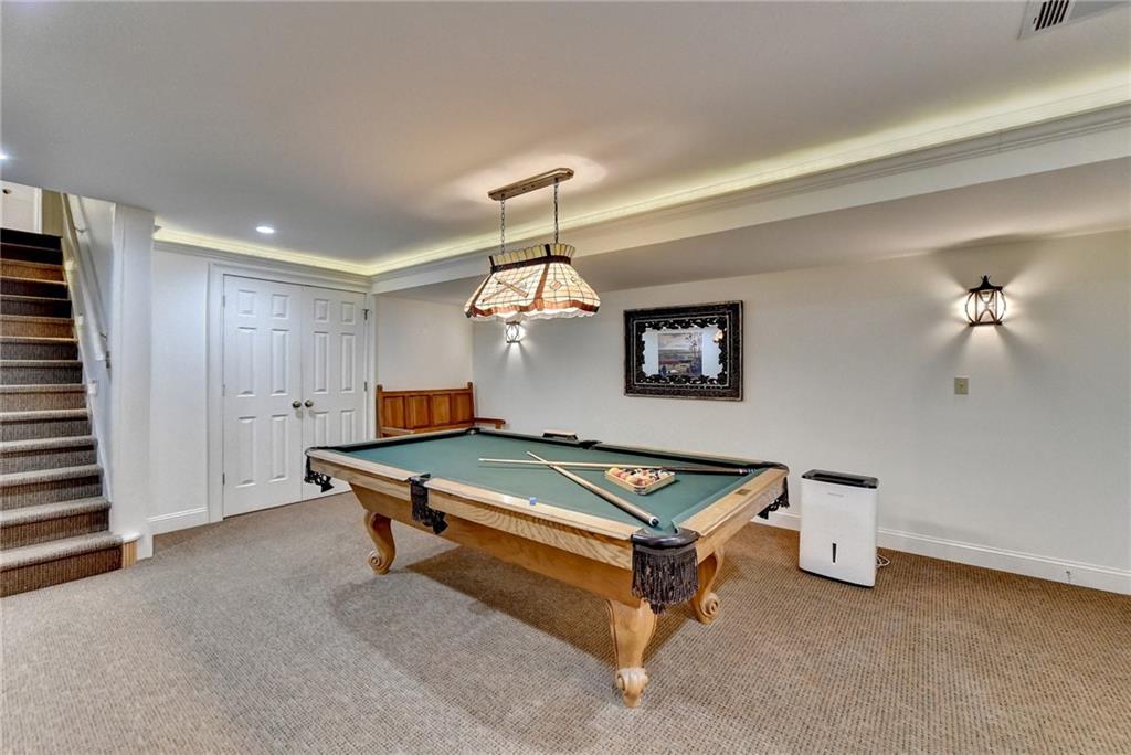 Game room with carpet floors, pool table, and a raised ceiling