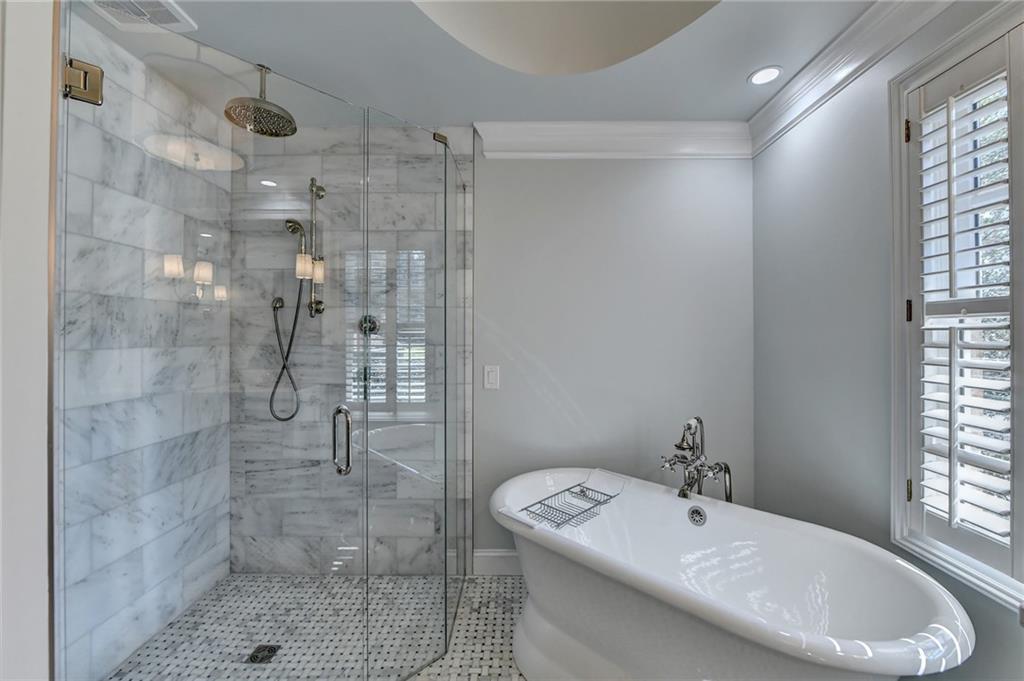 Bathroom with independent shower and bath, tile flooring, and ornamental molding