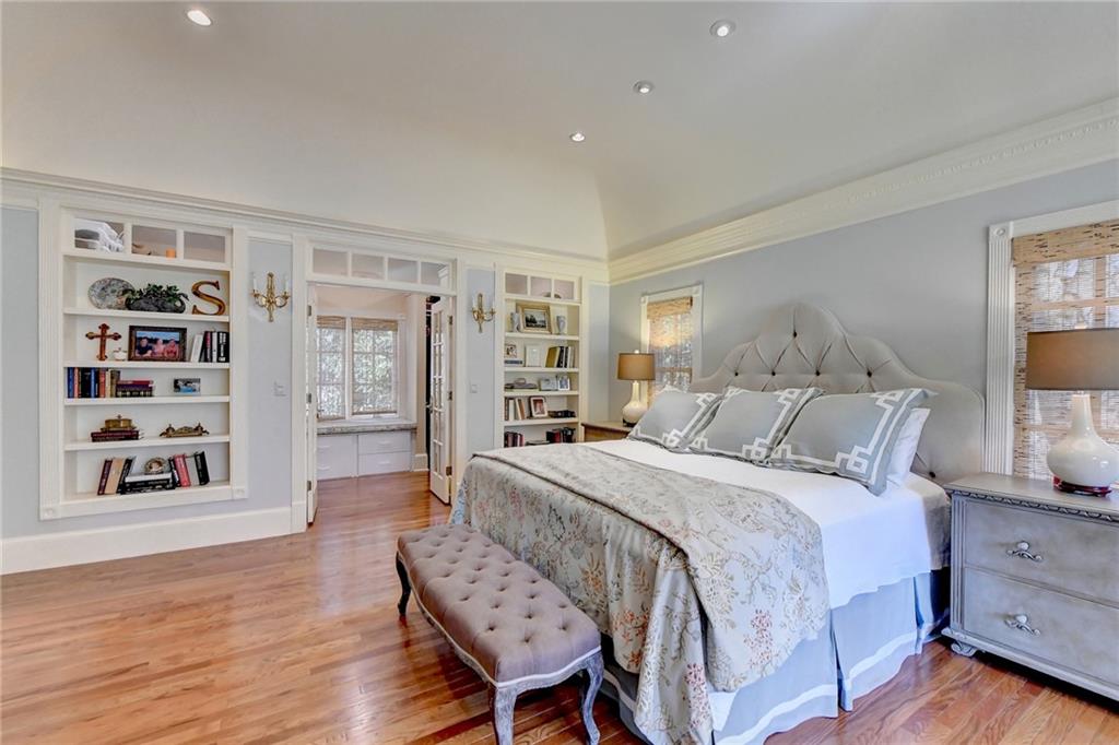 Bedroom featuring vaulted ceiling and hardwood / wood-style flooring
