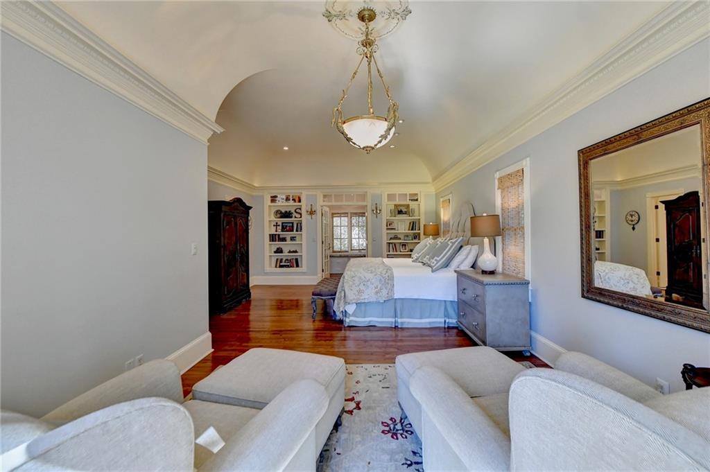 Bedroom featuring a chandelier, dark wood-type flooring, and ornamental molding