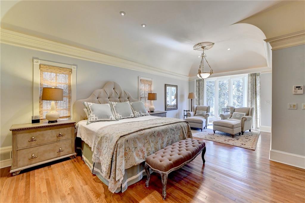 Bedroom with light hardwood / wood-style floors and ornamental molding