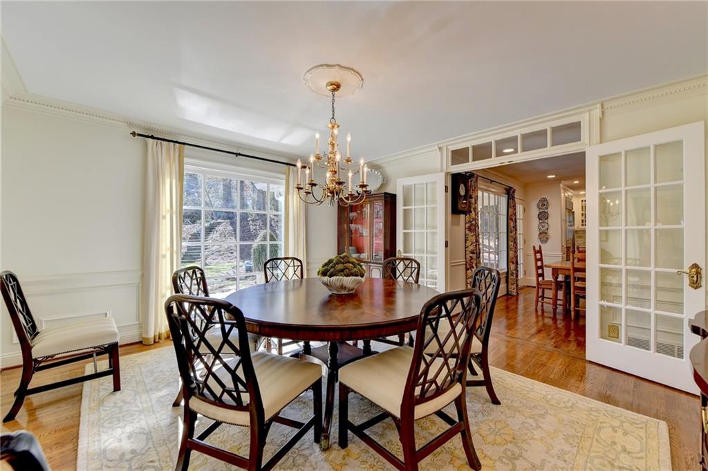 Dining room featuring a chandelier, light hardwood / wood-style floors, crown molding.