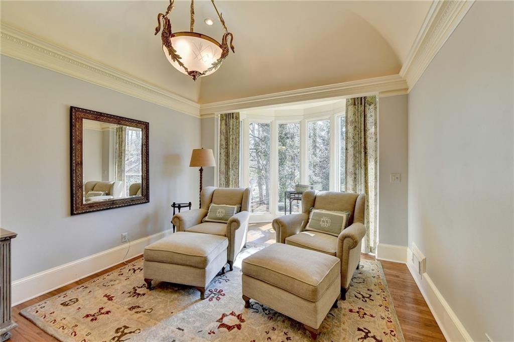 Sitting room with hardwood / wood-style flooring and ornamental molding