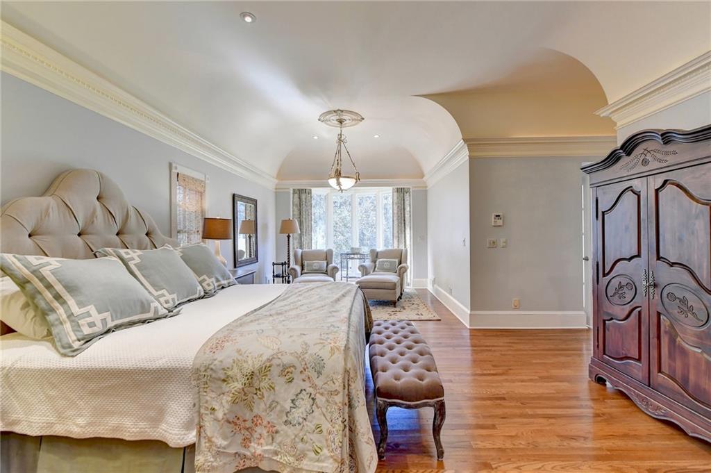 Bedroom featuring light hardwood / wood-style flooring and crown molding