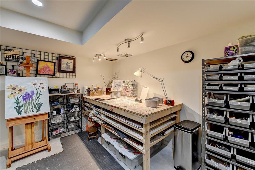rooHobby Room with track lighting and concrete flooring