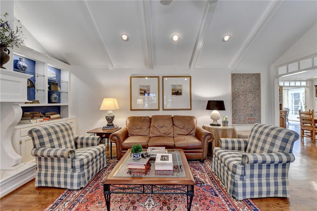 Living room featuring lofted ceiling with beams and light hardwood / wood-style floors