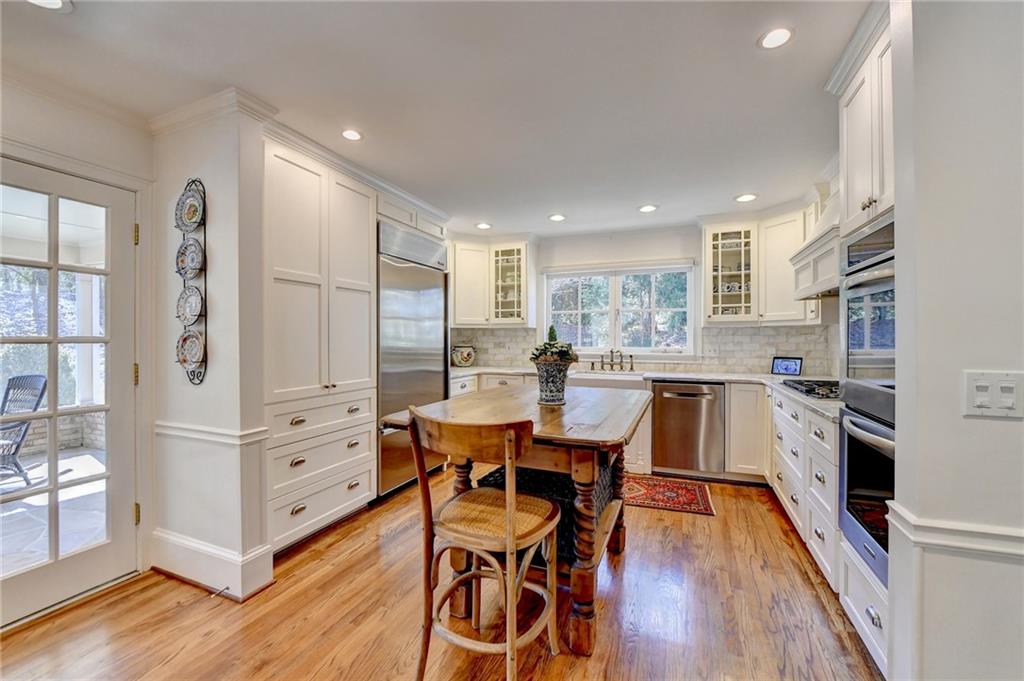 Kitchen featuring light hardwood / wood-style flooring, stainless steel appliances, and backsplash