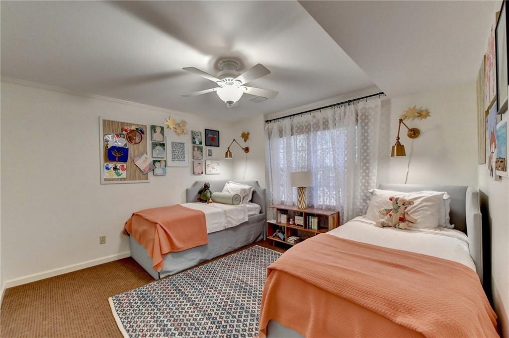 Carpeted bedroom with ceiling fan