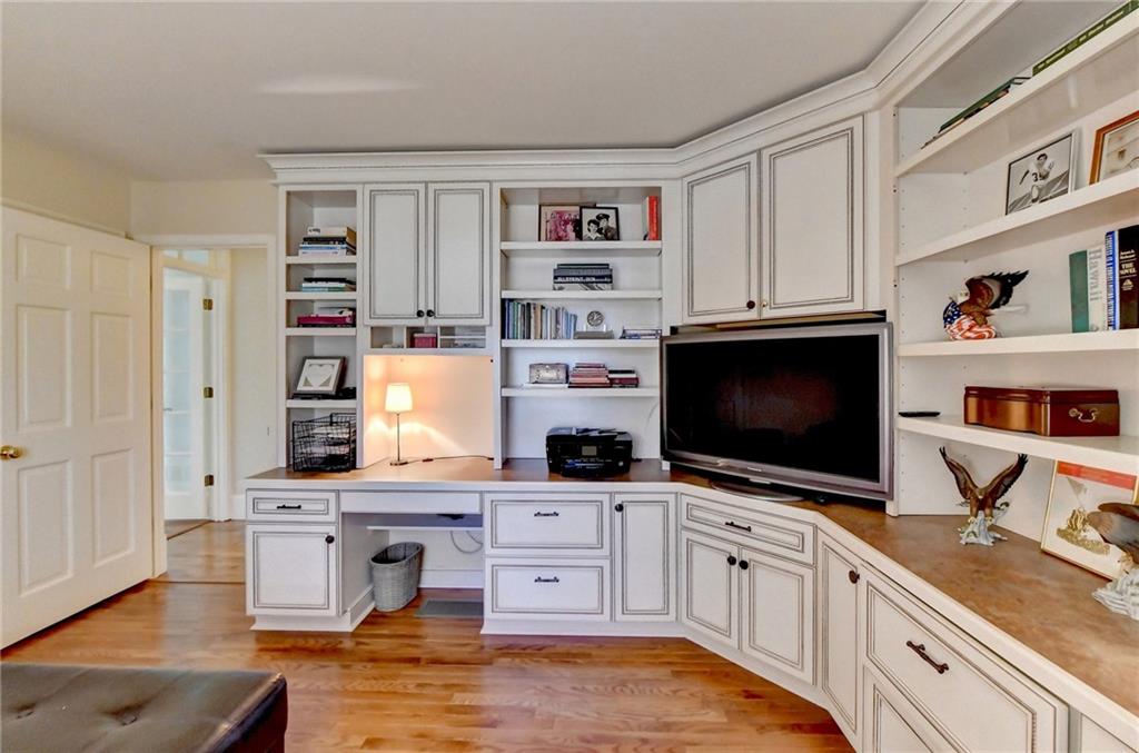 Home office featuring light hardwood / wood-style flooring and built in desk