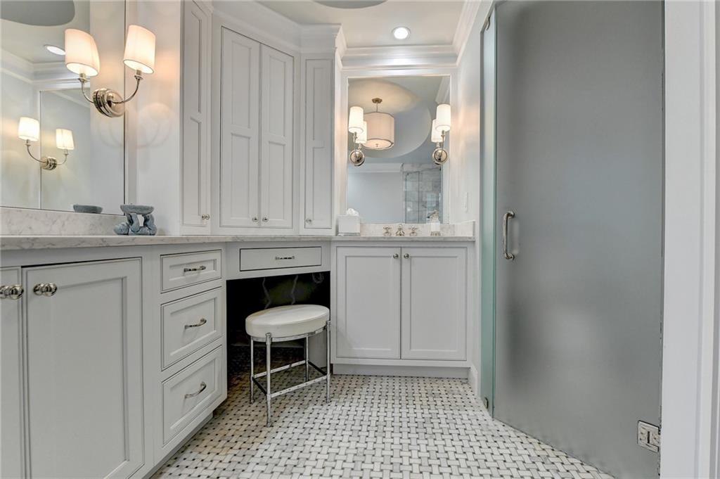 Bathroom featuring vanity, an inviting chandelier, tile floors, and ornamental molding