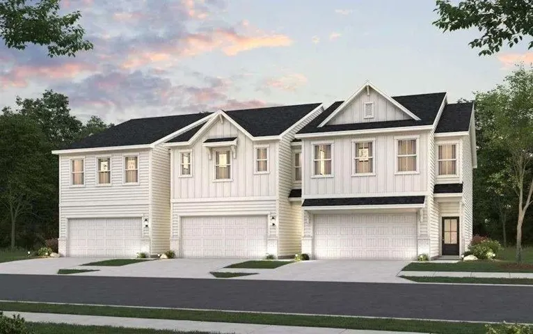 Contemporary farmhouse-style residences featuring white horizontal siding and dark shingle roofing