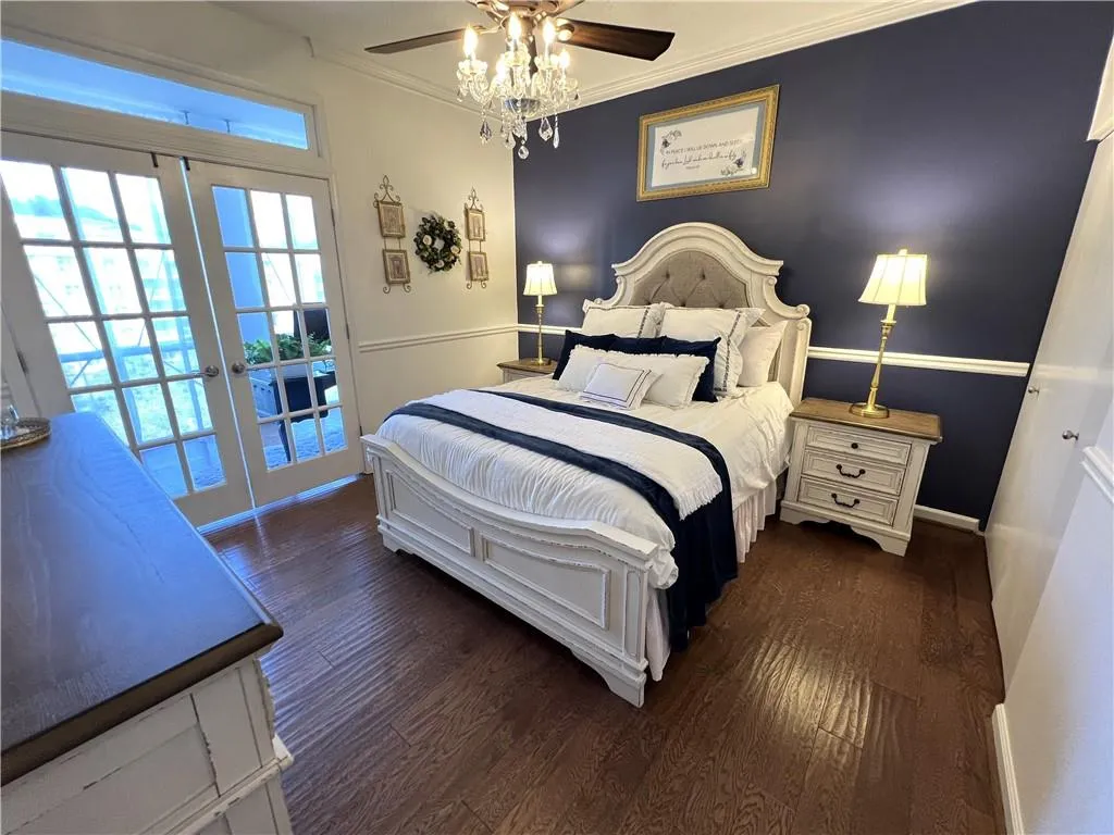 Bedroom suite with French doors and accent wall