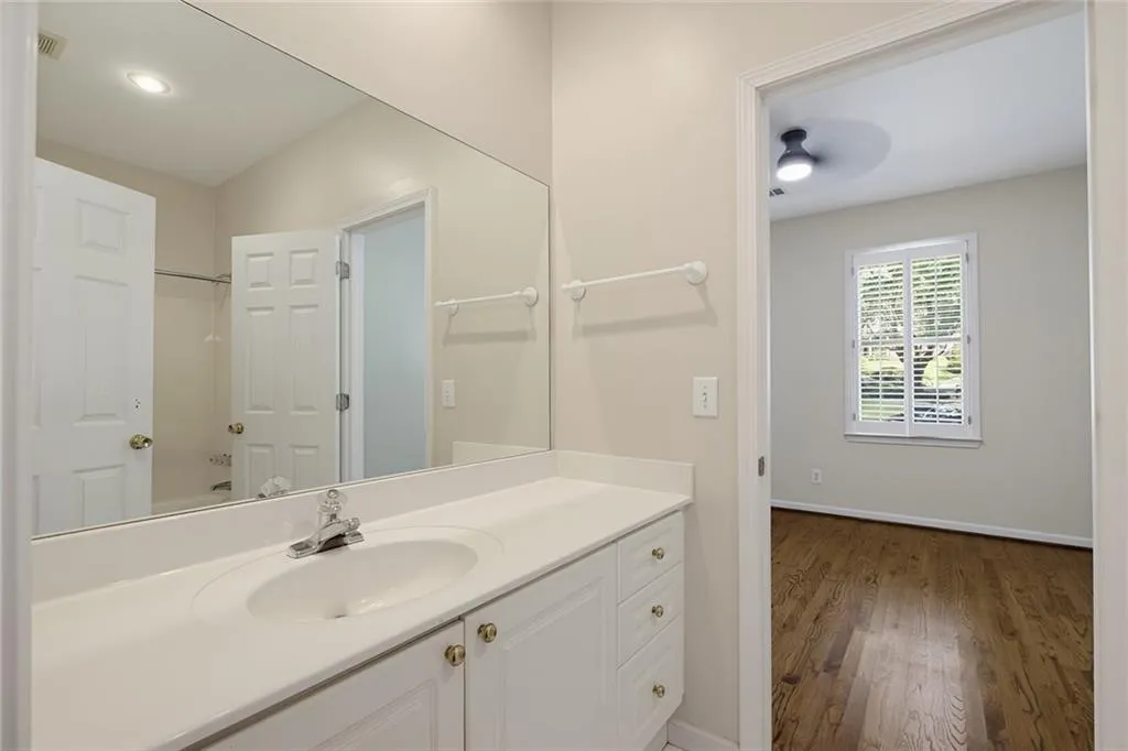 Vanity with an integrated sink, polished chrome faucet, and white cabinetry