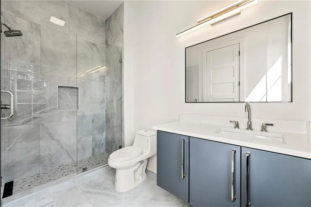 Full ensuite bath with vanity and a stall shower Full ensuite bath with vanity and a stall shower