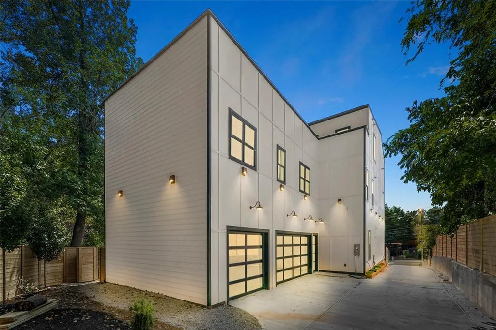 View of side of property featuring driveway and an attached garage View of side of property featuring driveway and an attached garage