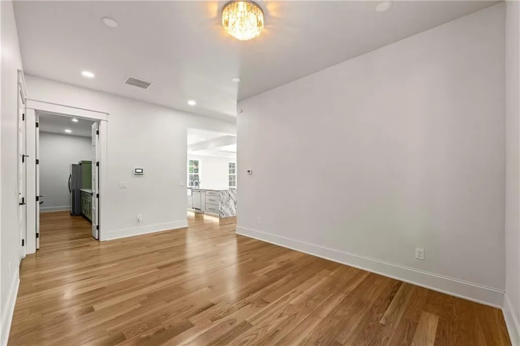 Sitting room near the kitchen with recessed lighting and light wood-flooring Sitting room near the kitchen with recessed lighting and light wood-flooring