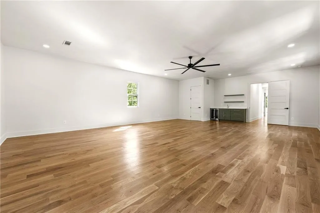 Flex room view with light wood-flooring, recessed lighting, a ceiling fan, and beverage cooler Flex room view with light wood-flooring, recessed lighting, a ceiling fan, and beverage cooler