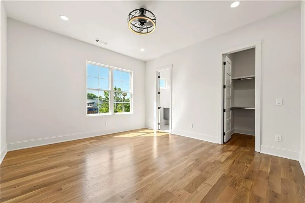 Bedroom #1 on the second level with light wood finished floors, a spacious custom closet, recessed lighting, and ensuite bath Bedroom #1 on the second level with light wood finished floors, a spacious custom closet, recessed lighting, and ensuite bath