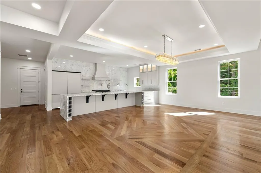 Living room featuring a tray ceiling and recessed lighting Living room featuring a tray ceiling and recessed lighting