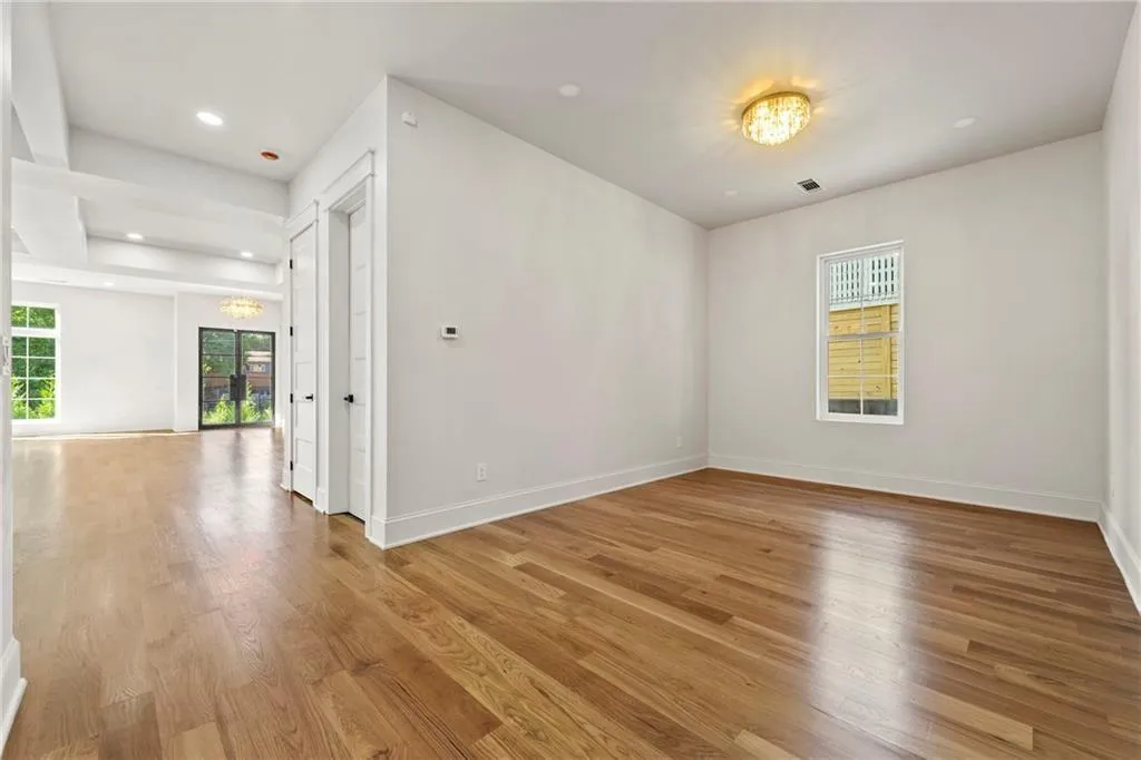 Sitting room near the kitchen with light wood floors and recessed lighting Sitting room near the kitchen with light wood floors and recessed lighting