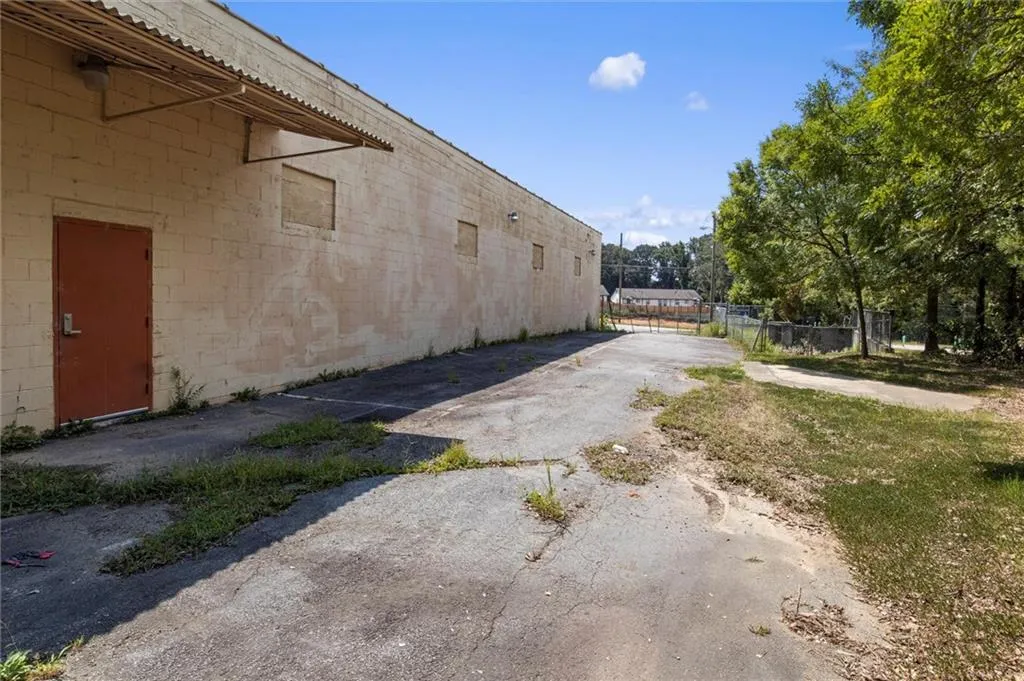 View of home's exterior featuring driveway and concrete block siding