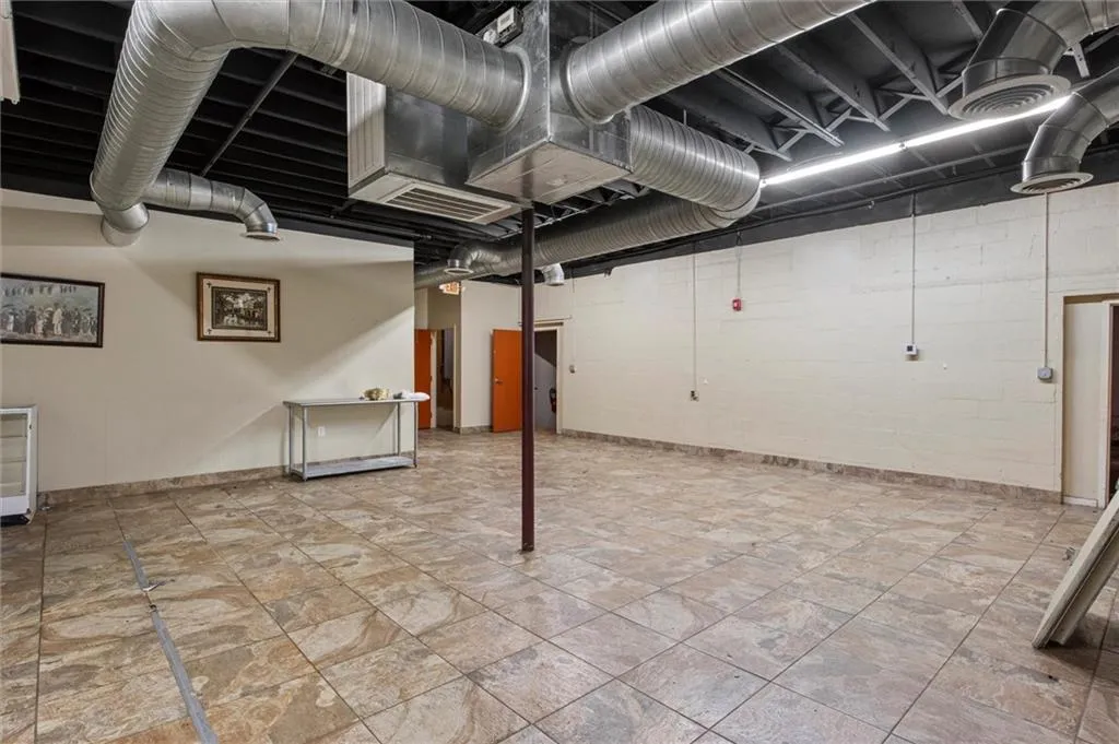 Finished below grade area featuring baseboards and concrete block wall