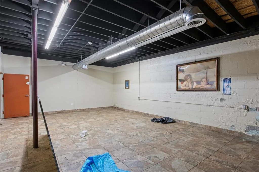 Finished below grade area with baseboards and concrete block wall