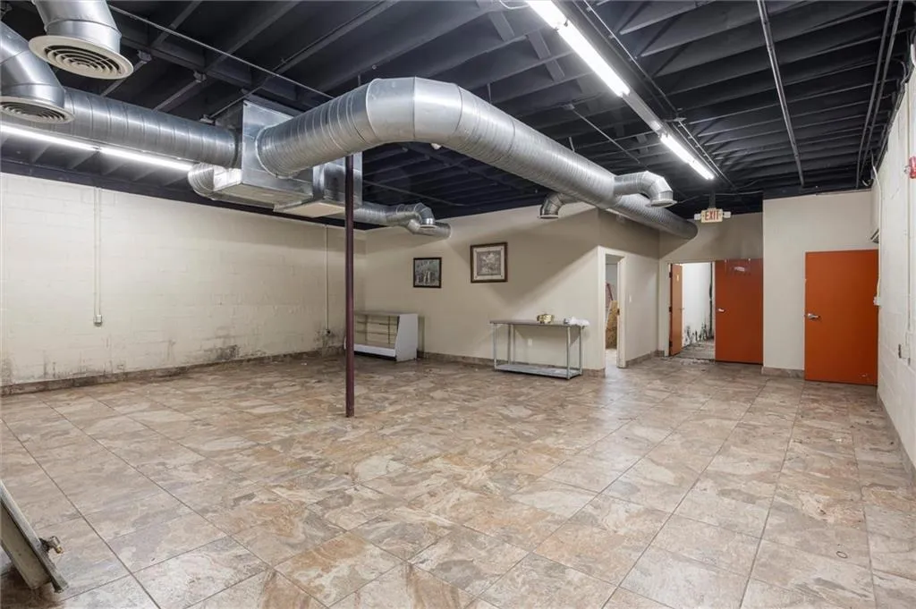 Finished basement featuring concrete block wall