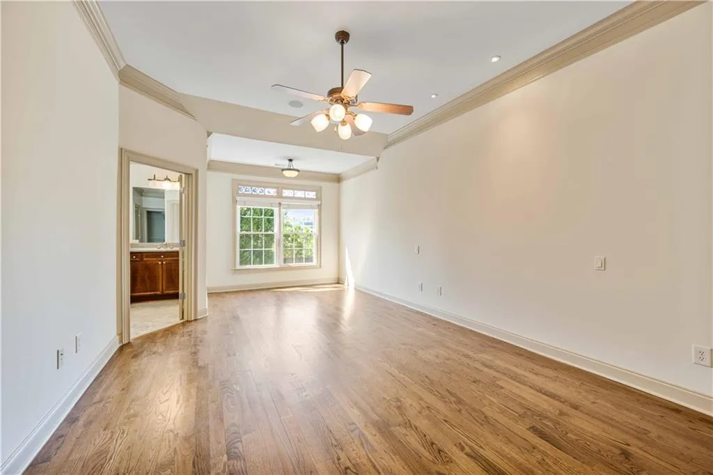 Tons of natural light in the primary bedroom! This space has a sitting area, an ensuite and two oversized walk in closets!