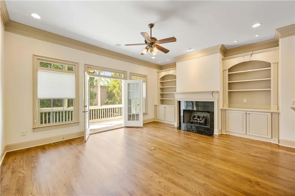 This comfortable fireside living room is a wonderful spot to entertain with easy access out to the covered patio, into the kitchen and dining areas