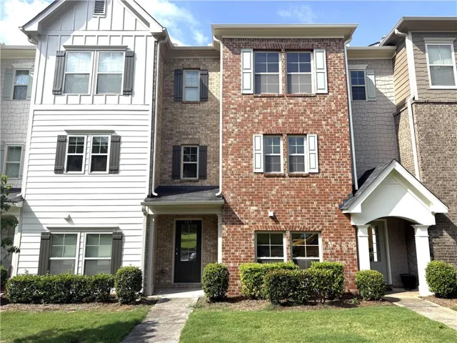 Brick and siding exterior with white shutters