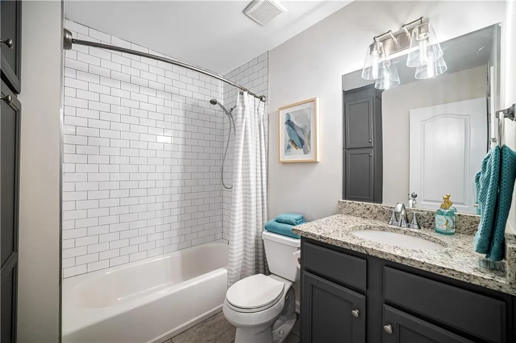 Bathroom featuring shower / tub combo and vanity