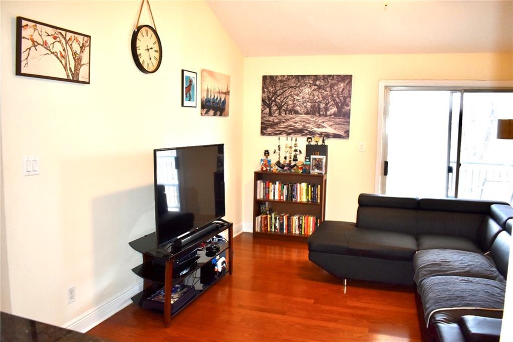Living room featuring, lofted ceiling, and a healthy amount of sunlight