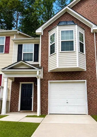 Brick and siding exterior featuring a covered entry porch