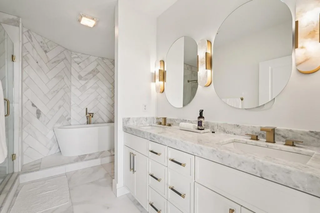 Spa-Style Ensuite With A Custom Marble Accent Wall, Marbletop Vanity, Soaking Tub, & Separate Shower