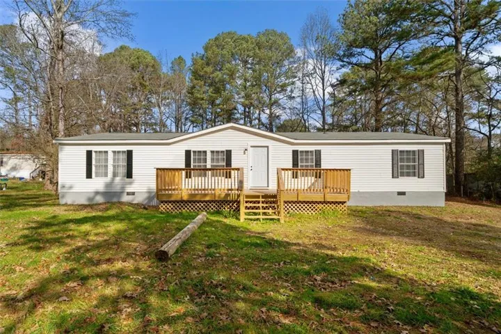 View of front of house featuring crawl space, a front lawn, and a deck