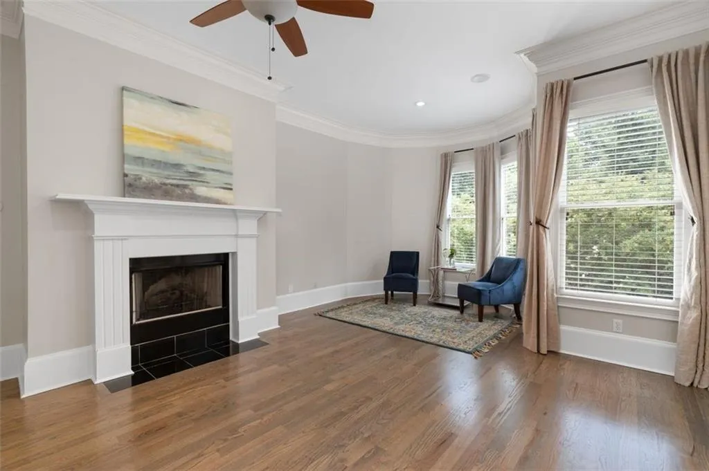 Sitting room in the primary suite with a fireplace