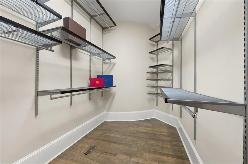 Primary walk-in closet with Elfa custom shelving