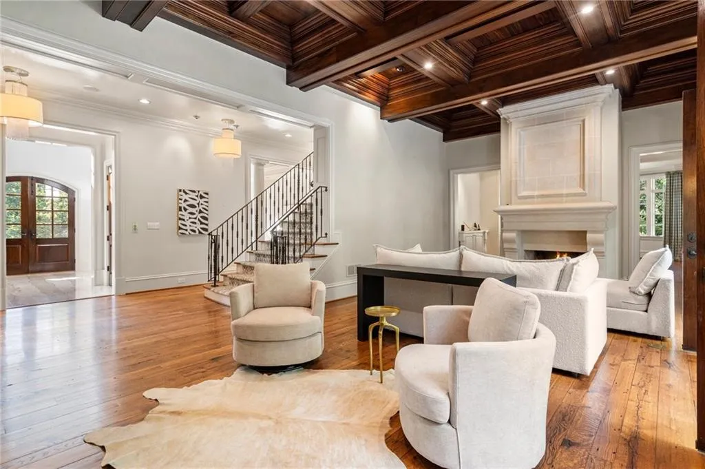Living room features 12 foot ceilings, fireplace and triple french doors out to the pool.