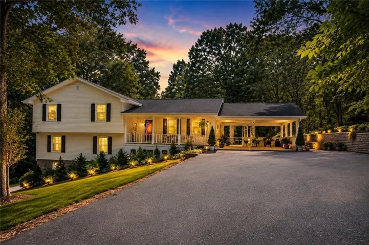 Two-story residence with a covered front porch and a covered carport