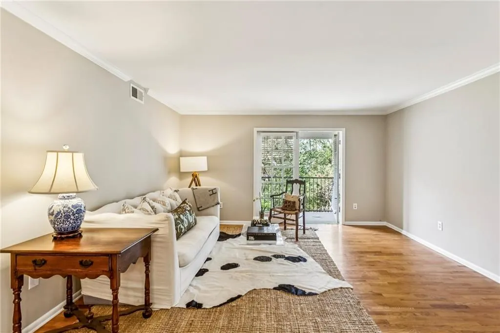 View of living area from Dining, Private balcony with French Doors & wooded view!
