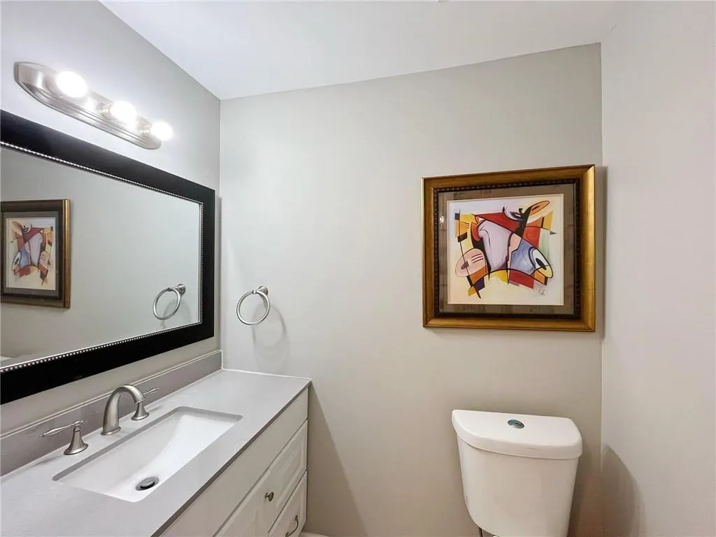 Half bath featuring toilet and vanity