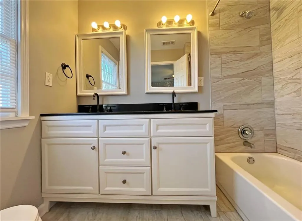 Full bath with tub / shower combination and double vanity