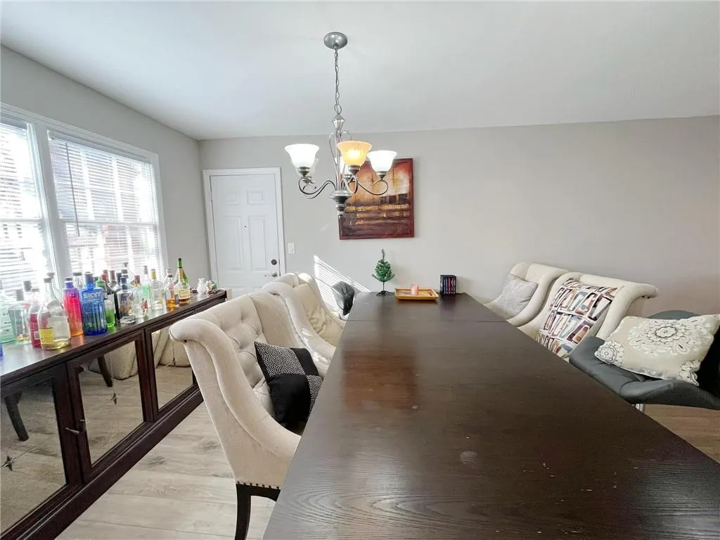 Dining area with a chandelier and wood finished floors