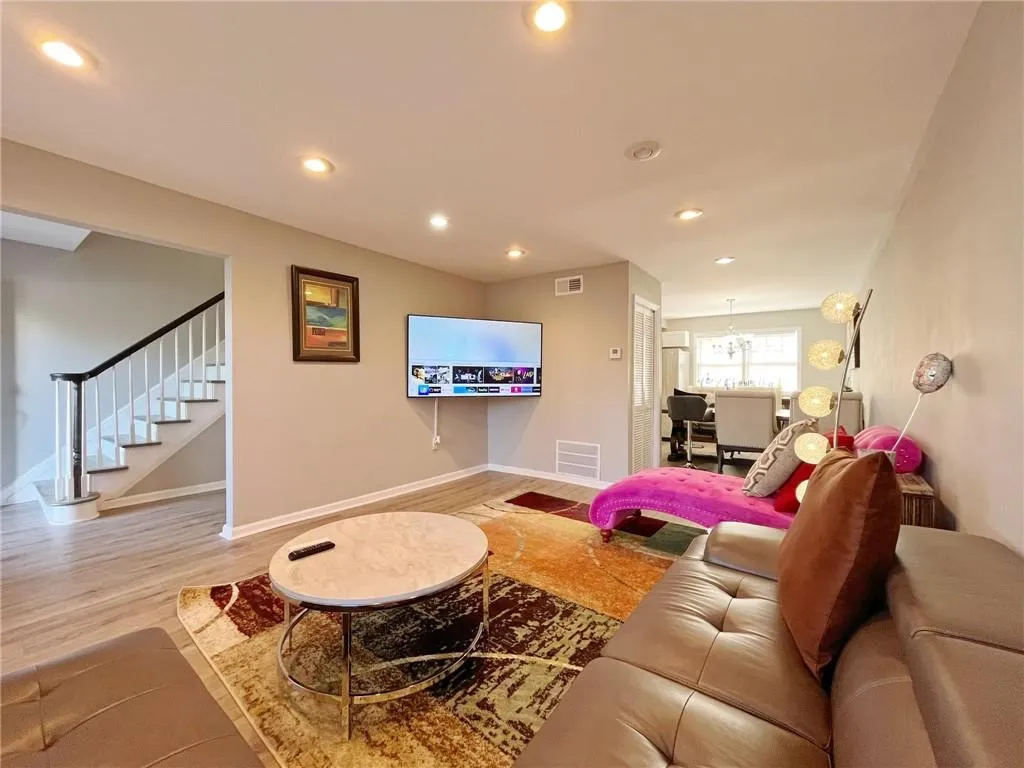 Living area featuring wood finished floors and hanging lights